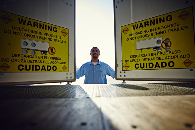 A man opens the doors to a truck trailer