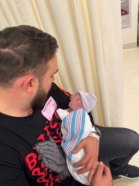 Hamza Aljamal holds his newborn son, Laith.