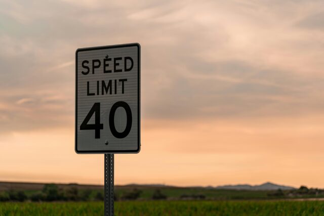 A speed limit sign on the side of a road tells drivers to drive 40 miles per hour