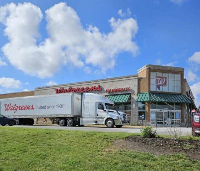 A Walgreens semitruck parked in front of a Walgreens store