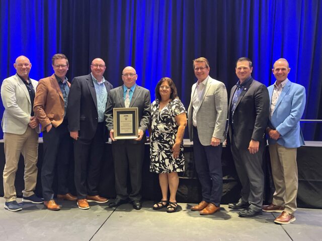 From left: Director of Safety Isaac Harmon, Vice President of Canadian Operations Matt Carr, Midwest Division Manager Richard Jones, Stuart Shuck, Barbara Shuck, CEO Duane Trower, Chief Operating Officer Dan Most, and President John Bickel Jr.