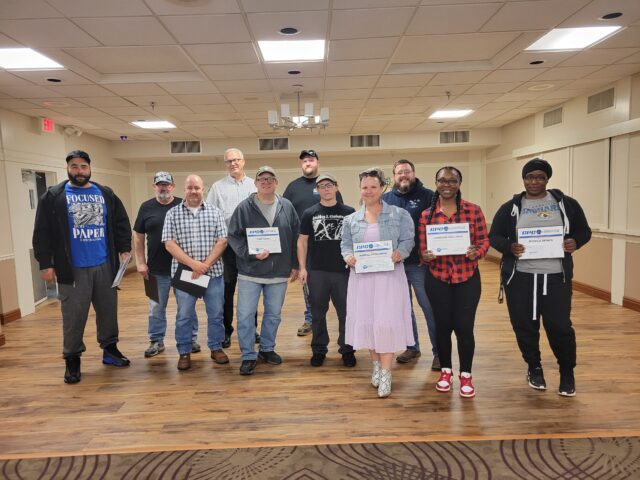 From left: Jason Pendleton, Chuck Blackaby, Tim Thorsen, Chuck Slapnika, Luke Corso, Mason Ruge, Jesse Johnson, Kendall Tomlinson, Patrick Kellenberger, Jasmeane Williams, and Monika Demps