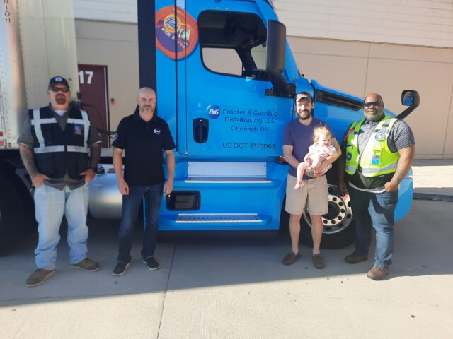 CPC driver Larry Hughes with members of the P&G management team, including Tony LaFontaine, Tim Trzepacz, and Aerence Stephens