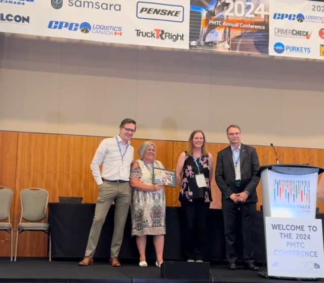 CPC Vice President of Canadian Operations Matt Carr (left) poses with CPC Dispatcher Carrie Scarselli as she accepts the 2024 Rick Austin Memorial Dispatcher of the Year Award during the PMTC Conference.