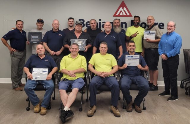 Standing: Safety Manager Joe Cosenza, Brian Perry, Distribution Center Manager Scott Kaplan, Jeffrey Gagnon, Randy Hall, Art Nelligan, Joe Wheeler, Robert Derderian, Alessandro Mota, Bryce Keeler and Division Manager Ken Pruitt. Seated: Dave Kenney, Steve Watson, Renato Moreira and Weber Monteiro.