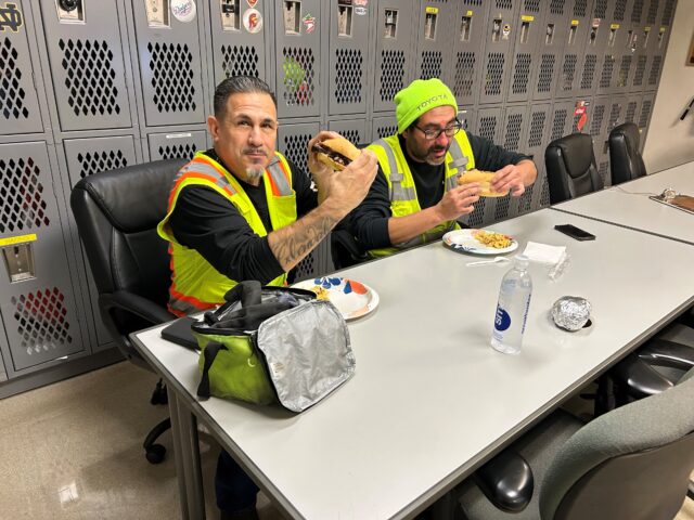 Truck drivers enjoy sandwiches