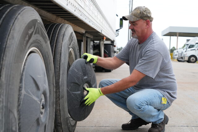 Joe Morgan inspects the tires of his truck
