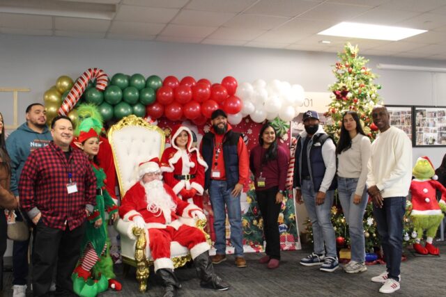Brian Kaempf (Santa), Melissa Milla (Mrs. Claus) and Alex Campos with the warehouse management team