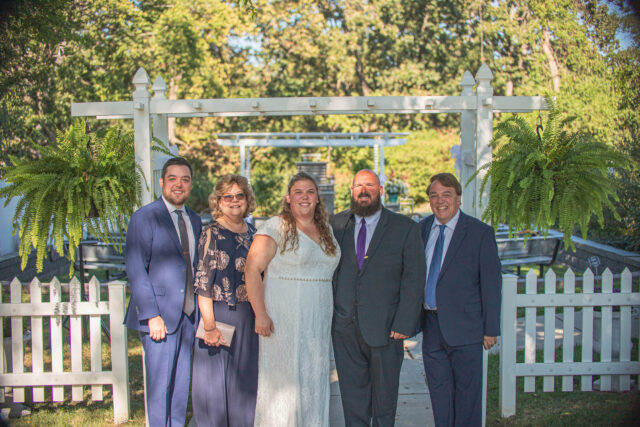 A family poses for a wedding photo